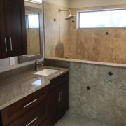 Bathroom with granite countertop and tiled shower Bathroom with granite countertop and tiled shower