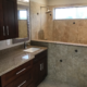 Bathroom with granite countertop and tiled shower